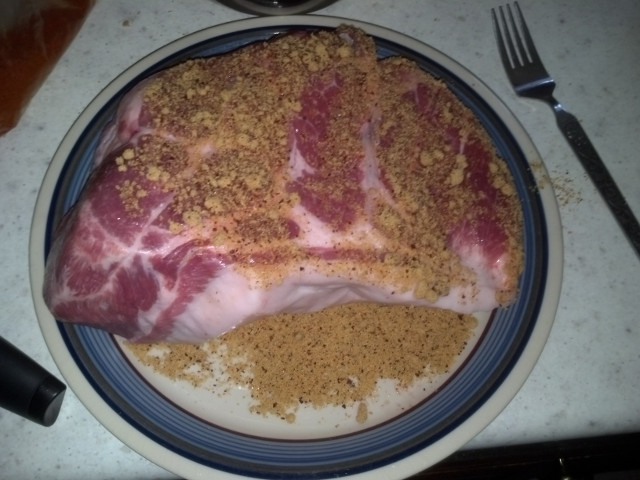 Uncooked pork shoulder with rub